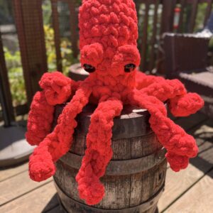 Purple plush octopus on barrel